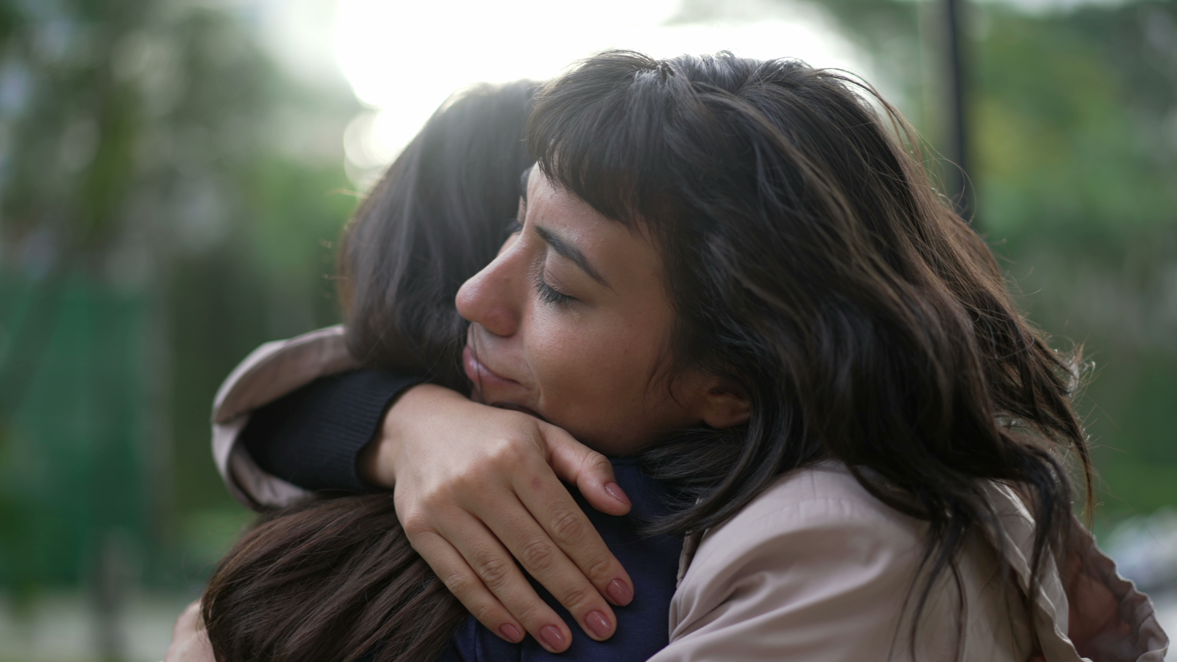 Woman embracing child in supportive hug